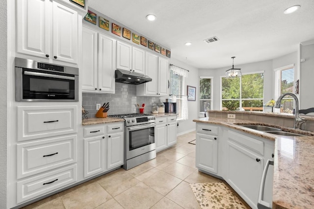 7900 Monona Ave, Austin, TX 78717 - kitchen featuring stainless steel gas stove, white cabinetry, under cabinet range hood, decorative backsplash, and recessed lighting