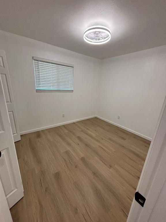 4608 E Village Ct, Austin, TX 78744 - unfurnished room with light wood-style floors and baseboards