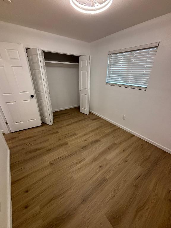 4608 E Village Ct, Austin, TX 78744 - unfurnished bedroom featuring wood finished floors and a closet