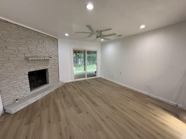 4608 E Village Ct, Austin, TX 78744 - unfurnished living room with a ceiling fan, a fireplace, recessed lighting, and wood finished floors