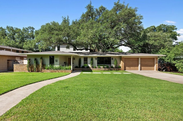 2517 Great Oaks Pkwy, Austin, TX 78756 - ranch-style home with an attached garage, concrete driveway, a front lawn, and a shingled roof