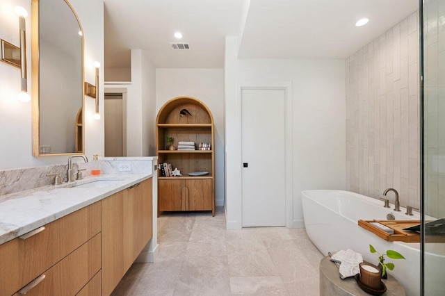 2517 Great Oaks Pkwy, Austin, TX 78756 - full bath featuring a freestanding bath, vanity, and recessed lighting