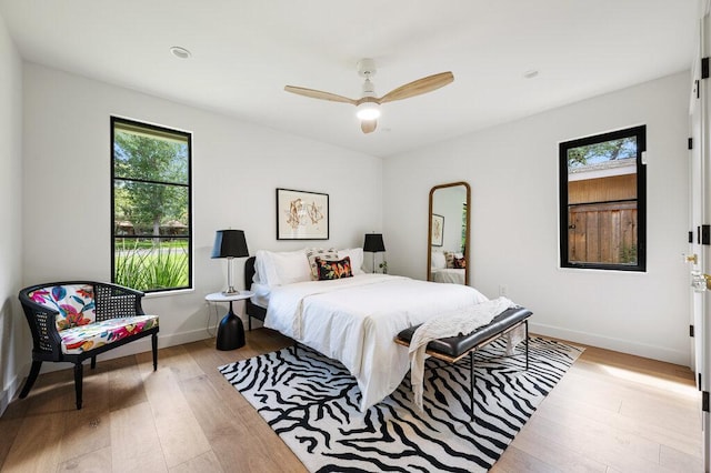 2517 Great Oaks Pkwy, Austin, TX 78756 - bedroom featuring multiple windows, wood-type flooring, and ceiling fan