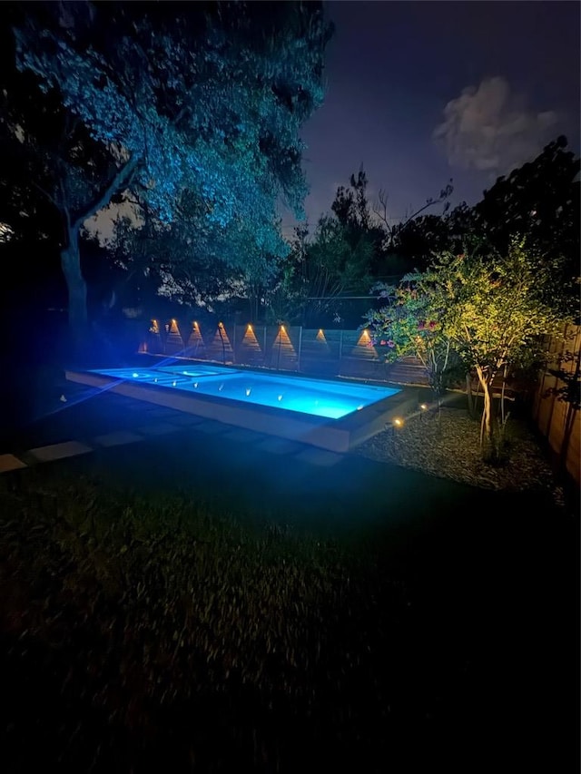 2517 Great Oaks Pkwy, Austin, TX 78756 - pool at twilight featuring a fenced backyard