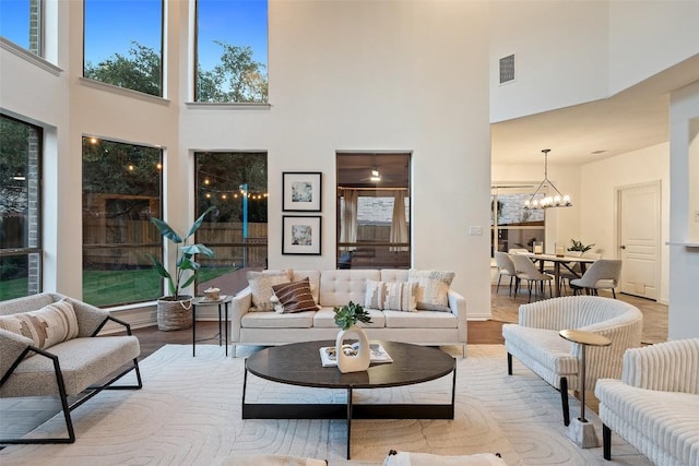 3803 Katie Ln, Cedar Park, TX 78613 - living room featuring a high ceiling, a chandelier, and wood finished floors