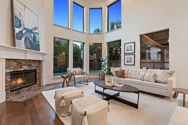 3803 Katie Ln, Cedar Park, TX 78613 - living room with wood-type flooring, a towering ceiling, and a fireplace