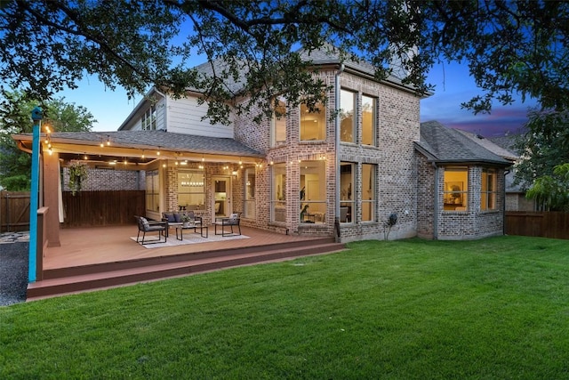 3803 Katie Ln, Cedar Park, TX 78613 - back of property at dusk featuring a deck, brick siding, and an outdoor living space