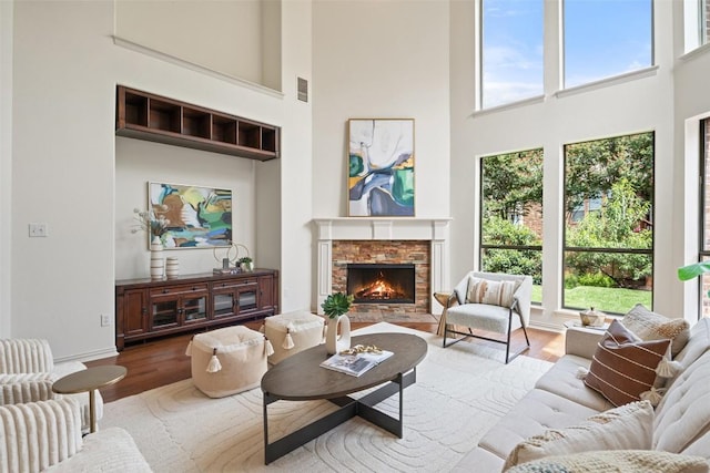 3803 Katie Ln, Cedar Park, TX 78613 - living room with a high ceiling, wood finished floors, and a brick fireplace