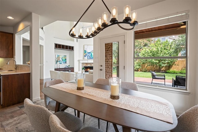 3803 Katie Ln, Cedar Park, TX 78613 - dining space featuring a chandelier, a lit fireplace, and recessed lighting