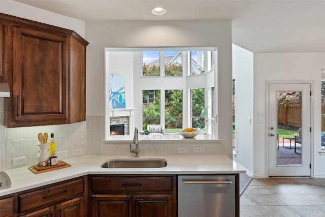 3803 Katie Ln, Cedar Park, TX 78613 - kitchen featuring stainless steel dishwasher, light countertops, tasteful backsplash, extractor fan, and a peninsula