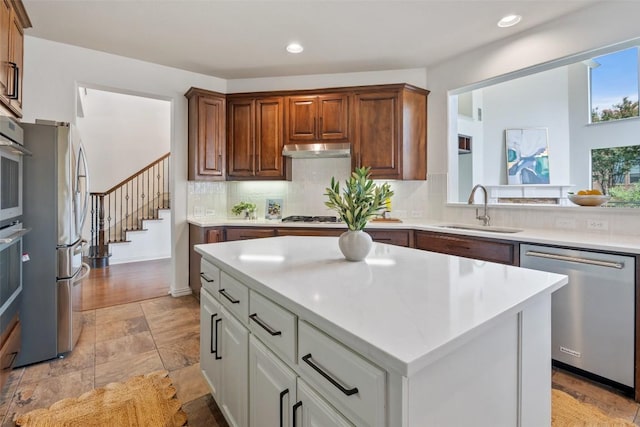 3803 Katie Ln, Cedar Park, TX 78613 - kitchen with appliances with stainless steel finishes, under cabinet range hood, recessed lighting, light countertops, and decorative backsplash