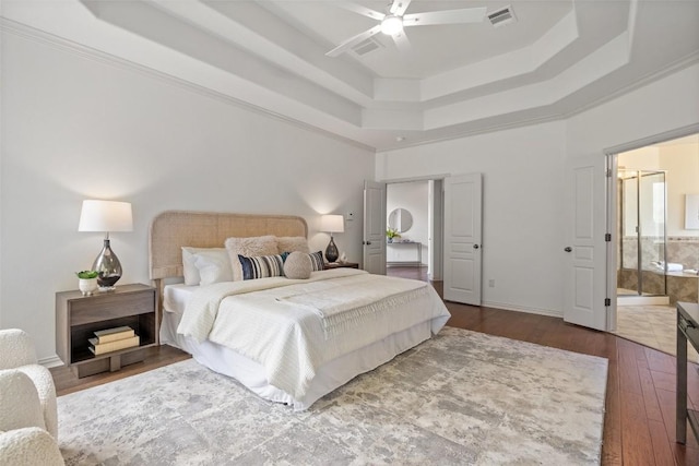 3803 Katie Ln, Cedar Park, TX 78613 - bedroom featuring a raised ceiling, hardwood / wood-style floors, ensuite bath, and a ceiling fan