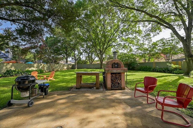 2400 Muirfield Cir, Austin, TX 78747 - fenced backyard with a fireplace and a patio