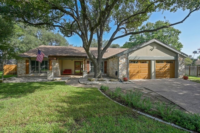 2400 Muirfield Cir, Austin, TX 78747 - ranch-style house with stone siding, asphalt driveway, and a garage