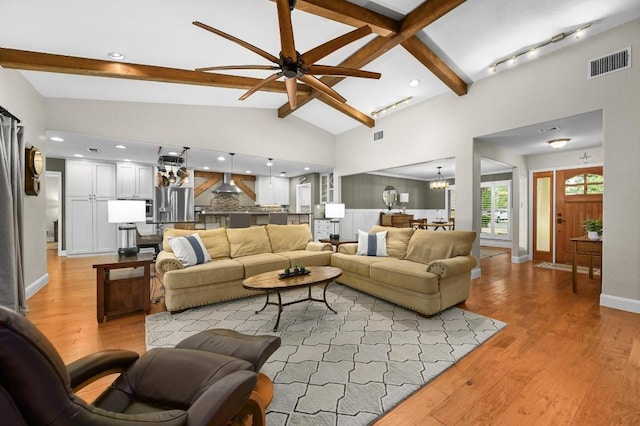 2400 Muirfield Cir, Austin, TX 78747 - living room with beamed ceiling, ceiling fan, a chandelier, light wood-type flooring, and high vaulted ceiling