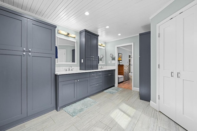 2400 Muirfield Cir, Austin, TX 78747 - full bathroom with double vanity, recessed lighting, crown molding, and wood ceiling