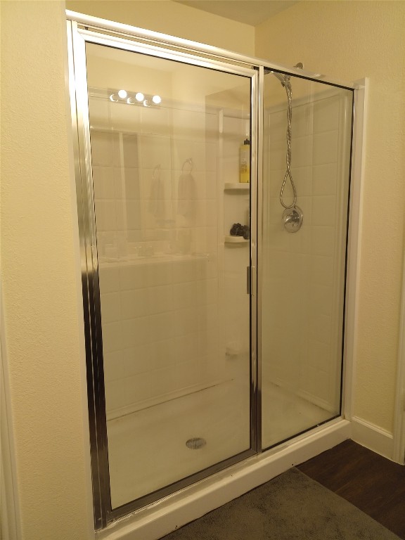 11540 Arbroath Ln, Austin, TX 78754 - full bathroom featuring a stall shower and wood finished floors