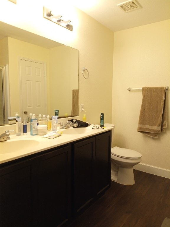 11540 Arbroath Ln, Austin, TX 78754 - bathroom featuring double vanity, wood finished floors, and an enclosed shower