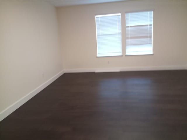 11540 Arbroath Ln, Austin, TX 78754 - empty room featuring baseboards and dark wood-style floors