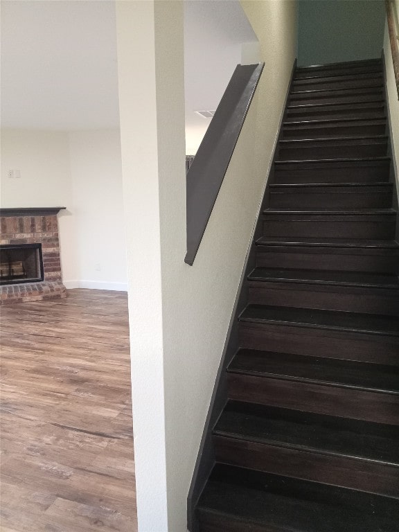 11540 Arbroath Ln, Austin, TX 78754 - stairs with wood finished floors and a brick fireplace