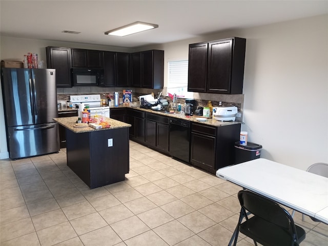 11540 Arbroath Ln, Austin, TX 78754 - kitchen with black appliances, dark cabinetry, and light stone countertops