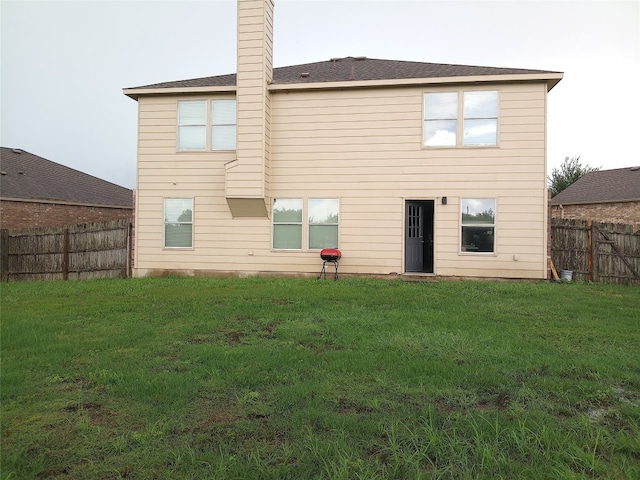 11540 Arbroath Ln, Austin, TX 78754 - back of house with a fenced backyard and a chimney