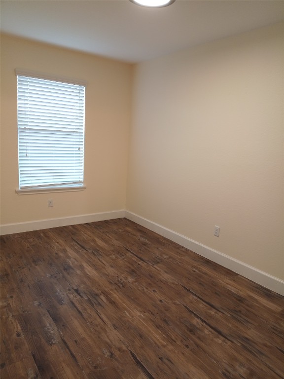 11540 Arbroath Ln, Austin, TX 78754 - spare room featuring dark wood-style flooring and baseboards