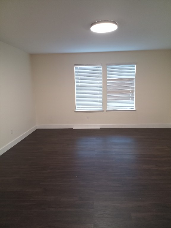11540 Arbroath Ln, Austin, TX 78754 - empty room featuring baseboards and dark wood-style flooring
