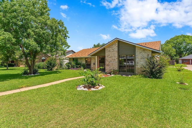 2014 Stagecoach Trl, Temple, TX 76502 - view of front of property with brick siding, a front lawn, and roof with shingles