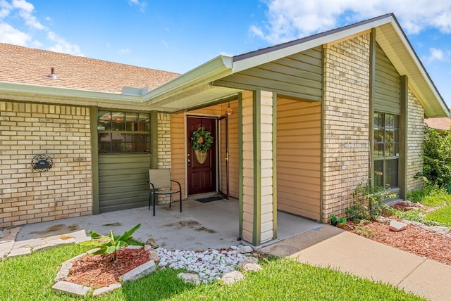 2014 Stagecoach Trl, Temple, TX 76502 - entrance to property with brick siding, a shingled roof, and a garage