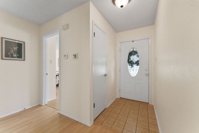 2014 Stagecoach Trl, Temple, TX 76502 - doorway to outside with a textured ceiling and light wood-style flooring