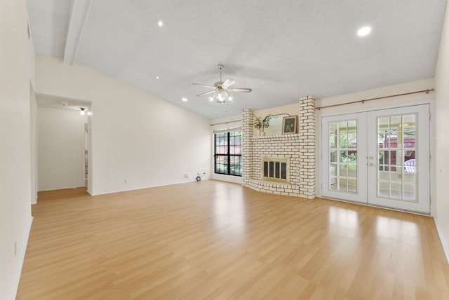 2014 Stagecoach Trl, Temple, TX 76502 - unfurnished living room featuring a ceiling fan, light wood-type flooring, french doors, a brick fireplace, and recessed lighting