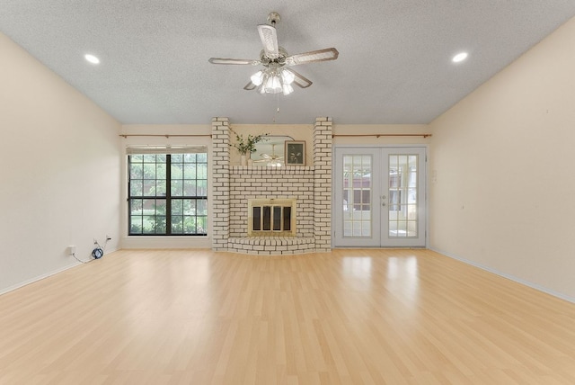 2014 Stagecoach Trl, Temple, TX 76502 - unfurnished living room featuring a textured ceiling, wood finished floors, recessed lighting, ceiling fan, and a fireplace