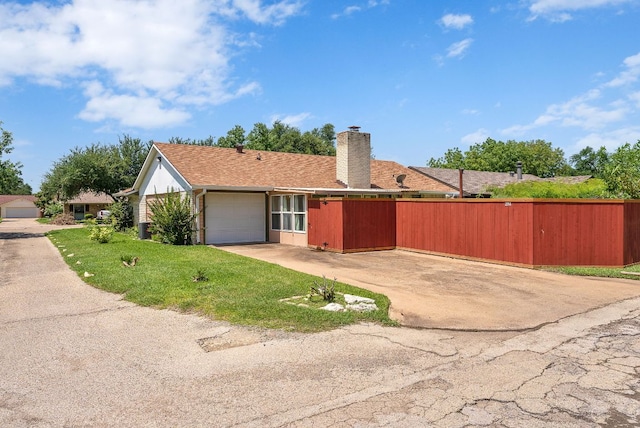 2014 Stagecoach Trl, Temple, TX 76502 - view of side of home with an attached garage, driveway, and a chimney