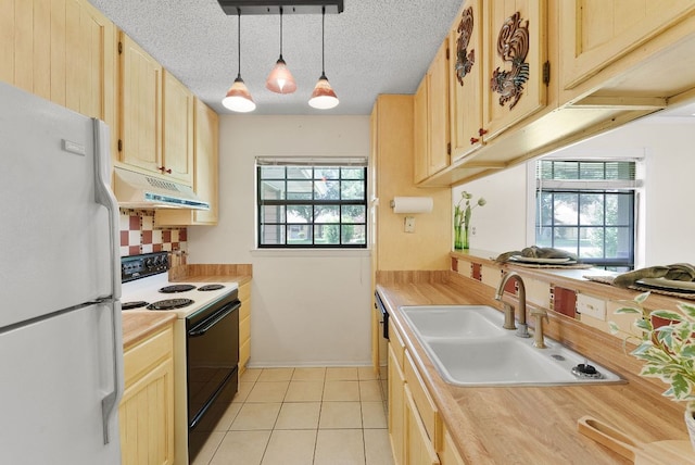 2014 Stagecoach Trl, Temple, TX 76502 - kitchen featuring freestanding refrigerator, range with electric cooktop, under cabinet range hood, light countertops, and plenty of natural light