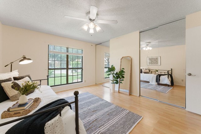 2014 Stagecoach Trl, Temple, TX 76502 - bedroom with a textured ceiling, light wood-style flooring, and a ceiling fan