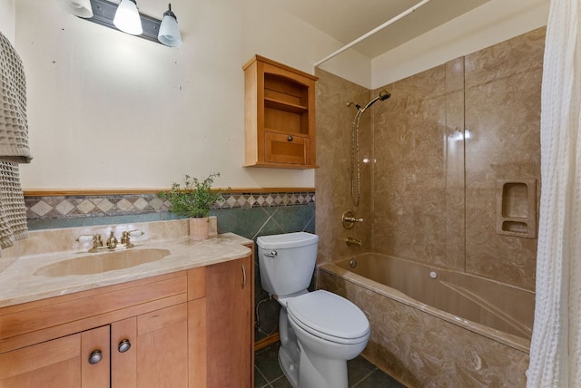 2014 Stagecoach Trl, Temple, TX 76502 - bathroom with tiled shower / bath combo, tile walls, vanity, tile patterned flooring, and wainscoting
