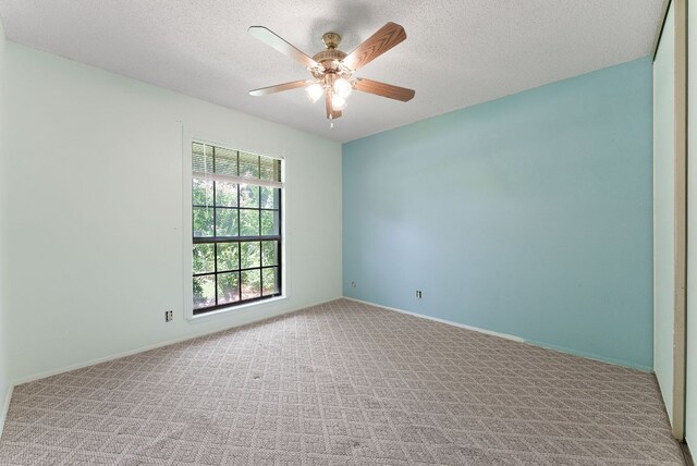 2014 Stagecoach Trl, Temple, TX 76502 - spare room with light colored carpet, a ceiling fan, and a textured ceiling