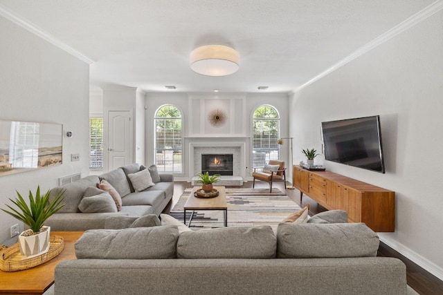 11235 Tracton Ln, Austin, TX 78739 - living area featuring wood finished floors, ornamental molding, and a warm lit fireplace