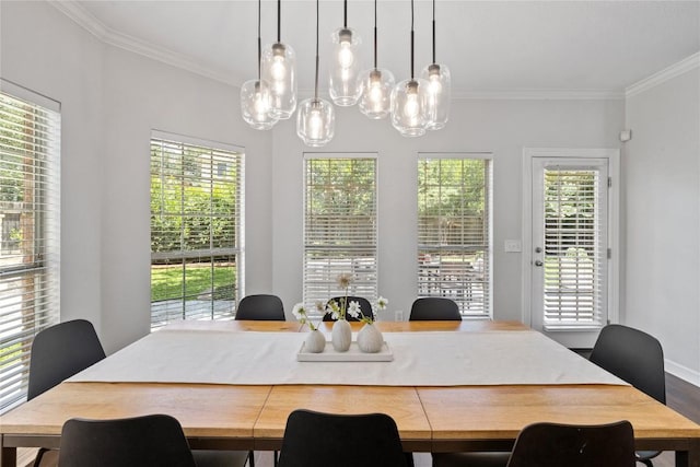 11235 Tracton Ln, Austin, TX 78739 - dining area featuring crown molding, a chandelier, plenty of natural light, and wood finished floors