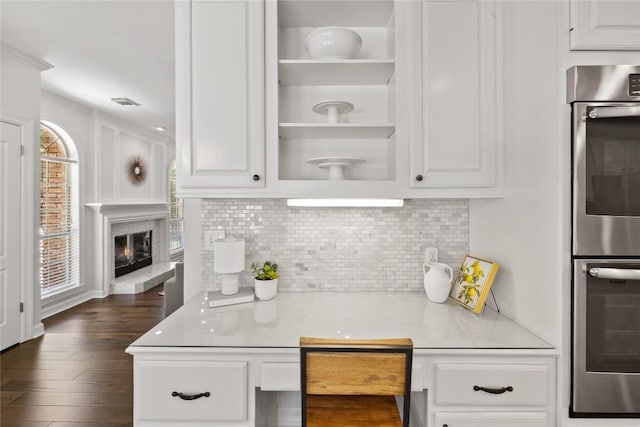 11235 Tracton Ln, Austin, TX 78739 - kitchen with double oven, light countertops, tasteful backsplash, and white cabinetry