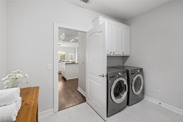 11235 Tracton Ln, Austin, TX 78739 - washroom with washing machine and dryer and cabinet space