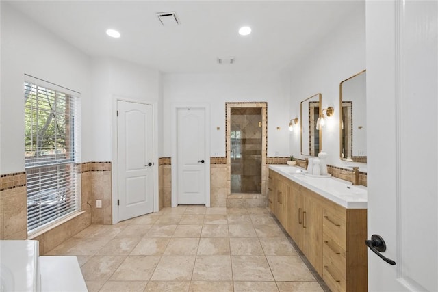 11235 Tracton Ln, Austin, TX 78739 - full bathroom featuring a shower stall, double vanity, a tub, tile patterned floors, and recessed lighting