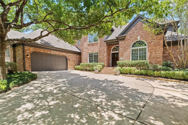 11235 Tracton Ln, Austin, TX 78739 - traditional-style house featuring brick siding, concrete driveway, a garage, and roof with shingles