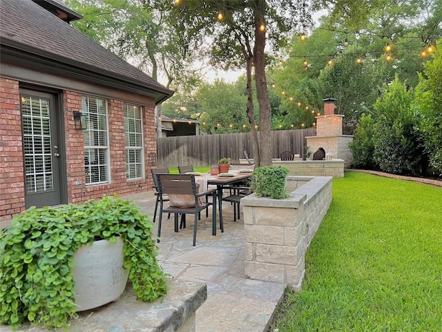 11235 Tracton Ln, Austin, TX 78739 - view of patio with a fireplace and outdoor dining space
