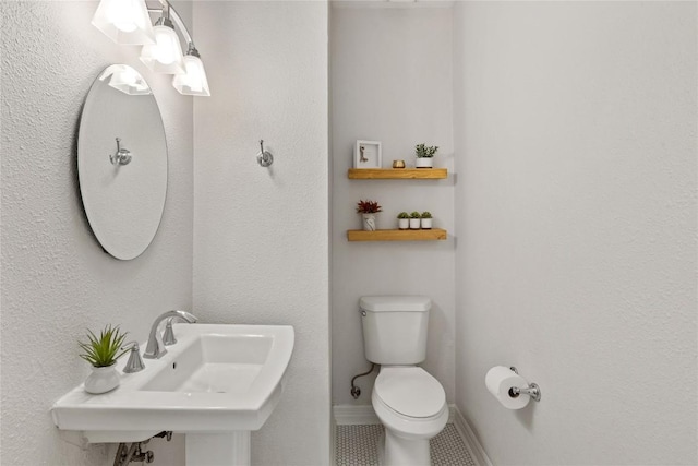 11235 Tracton Ln, Austin, TX 78739 - half bathroom with toilet and tile patterned floors