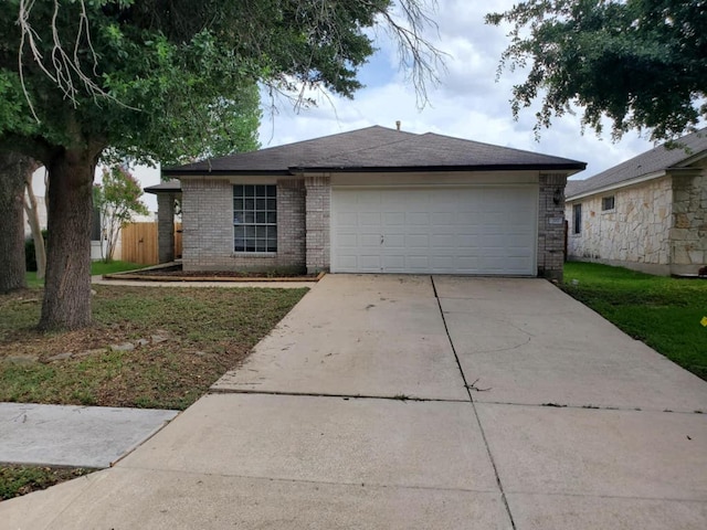 707 Johnny Bench, Round Rock, TX 78665 - ranch-style house with brick siding, driveway, an attached garage, and roof with shingles