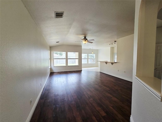 707 Johnny Bench, Round Rock, TX 78665 - unfurnished living room with a ceiling fan, dark wood-style flooring, lofted ceiling, a textured ceiling, and a textured wall