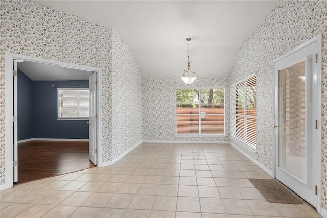 403 Warm Breeze Cv, Austin, TX 78717 - unfurnished dining area featuring wallpapered walls, vaulted ceiling, and light tile patterned floors
