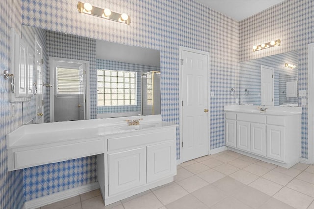 403 Warm Breeze Cv, Austin, TX 78717 - bathroom with tile patterned floors, wallpapered walls, and two vanities
